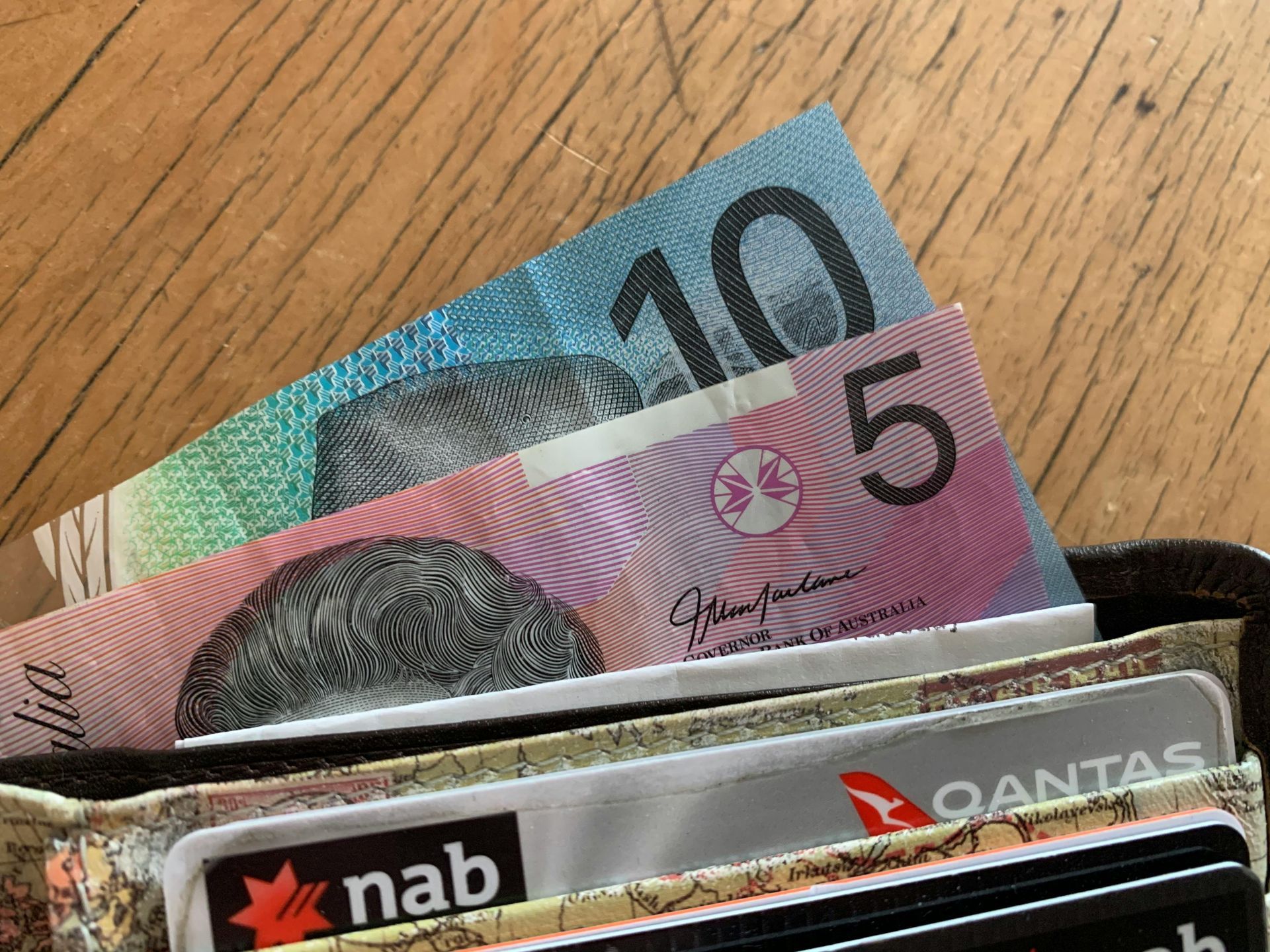 A wallet with a nab card and a qantas card