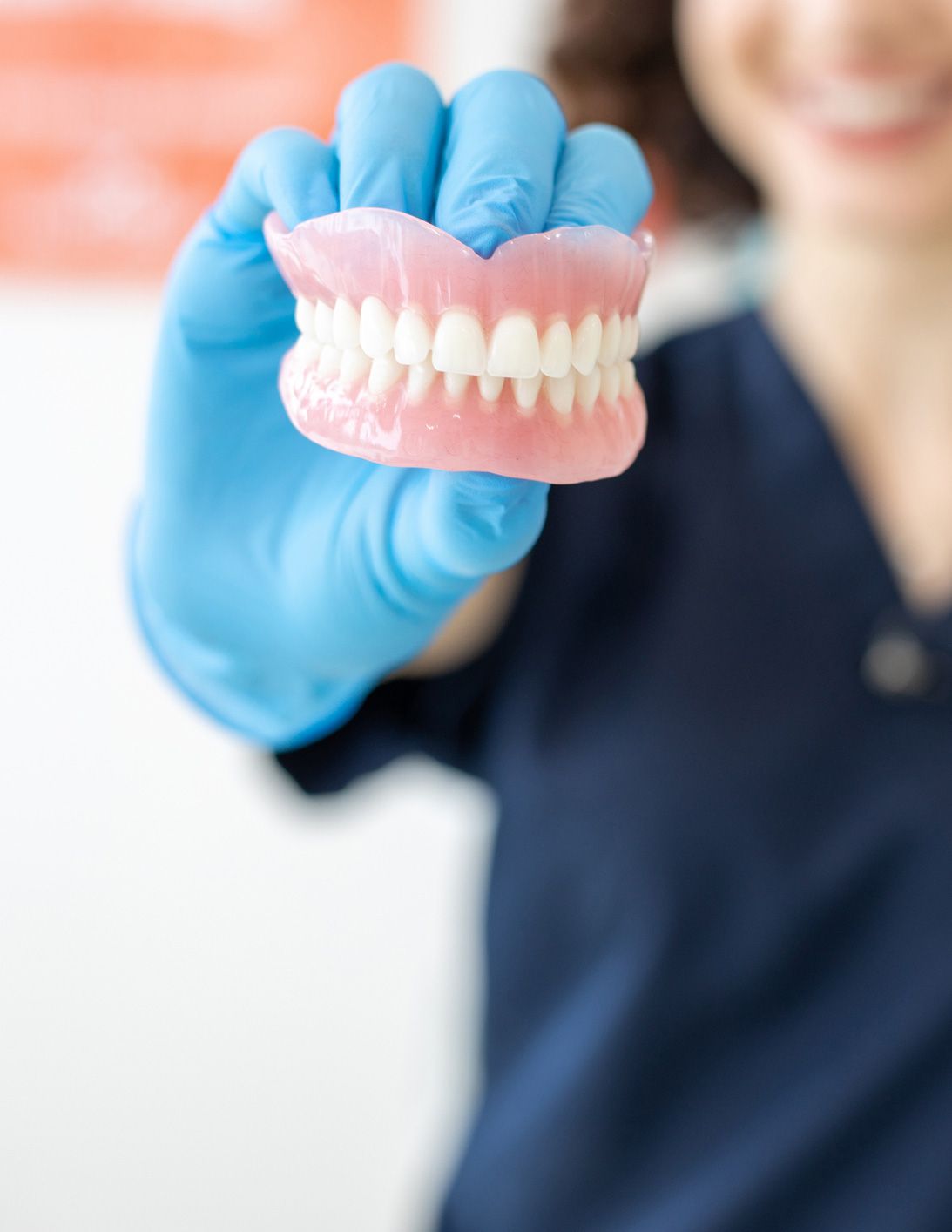Dentist Showing Dentures — Central Coast, NSW — Peninsula Denture Centre