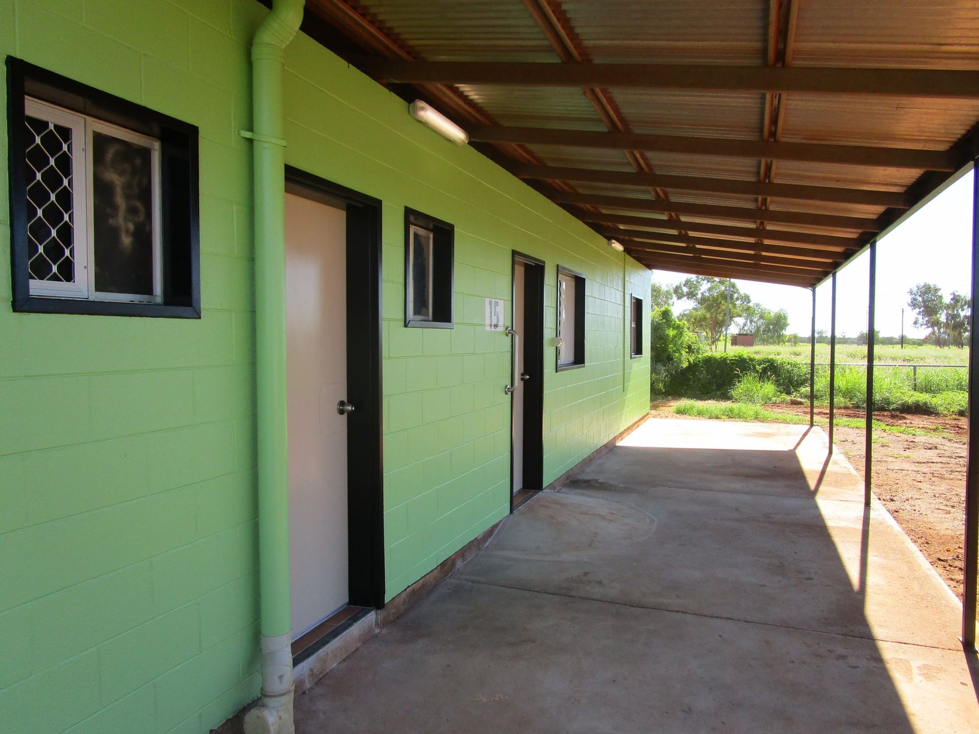 A Green Building With A Covered Walkway Leading To It β Bullant Building In Ciccone, NT