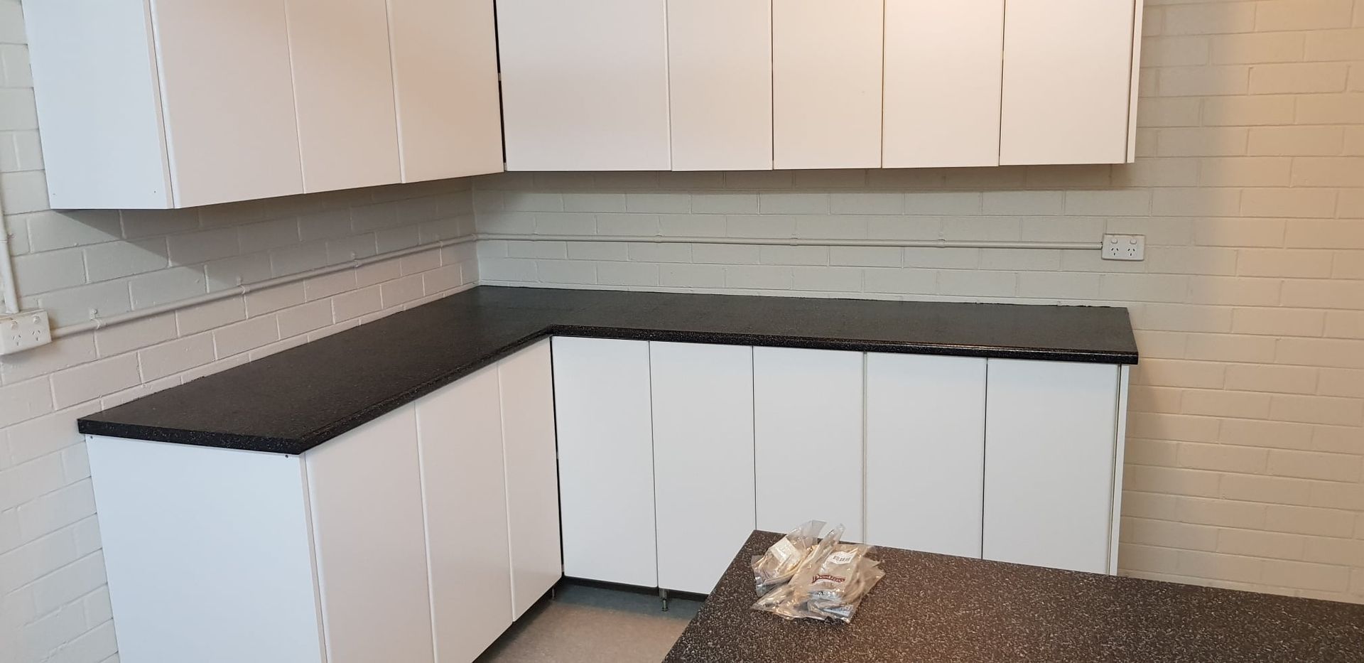 A Kitchen With White Cabinets β Bullant Building In Ciccone, NT