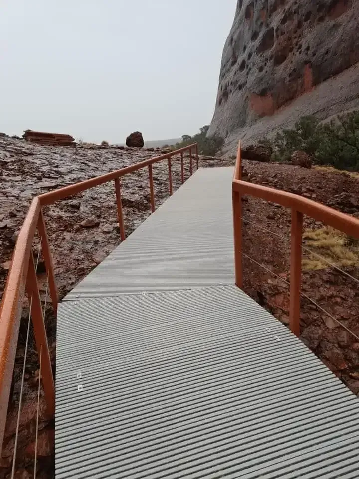 A Wooden Walkway Leading To A Mountain With A Railing β Bullant Building In Ciccone, NT