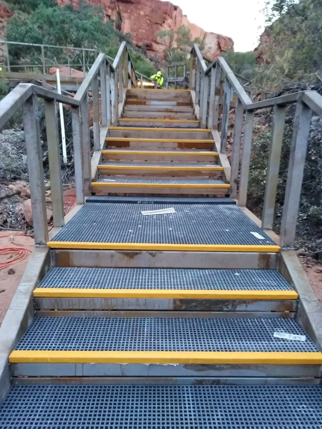 A Set Of Metal Stairs With Yellow Steps And A Wooden Railing β Bullant Building In Ciccone, NT