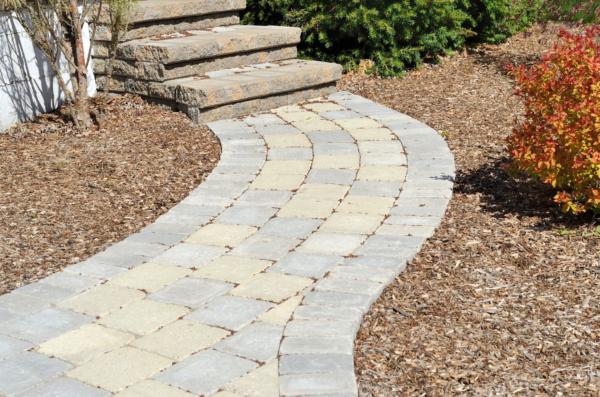 A brick walkway leading to a set of stairs