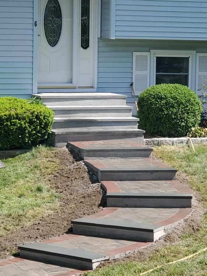 A large lush green lawn with trees in the background