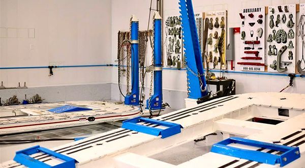 A blue and white machine is sitting in a garage.