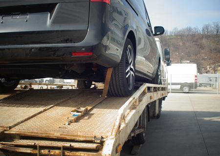 A car is sitting on top of a tow truck.