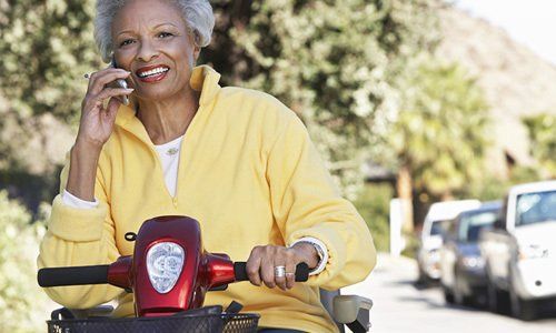 Elderly Woman Riding A Scooter
