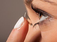 Contacts — Woman Putting On Contact Lenses in St. Helena, CA