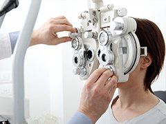 Glaucoma — Woman Using Phoropter in Saint Helena, CA