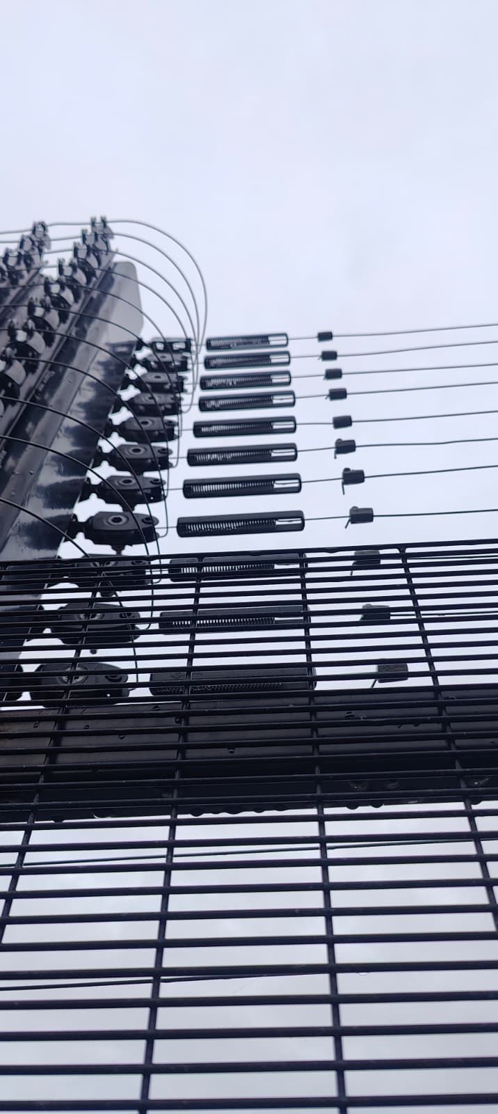 Perimeter security fence with anti-climb fence topper used as part of a layered perimeter detection