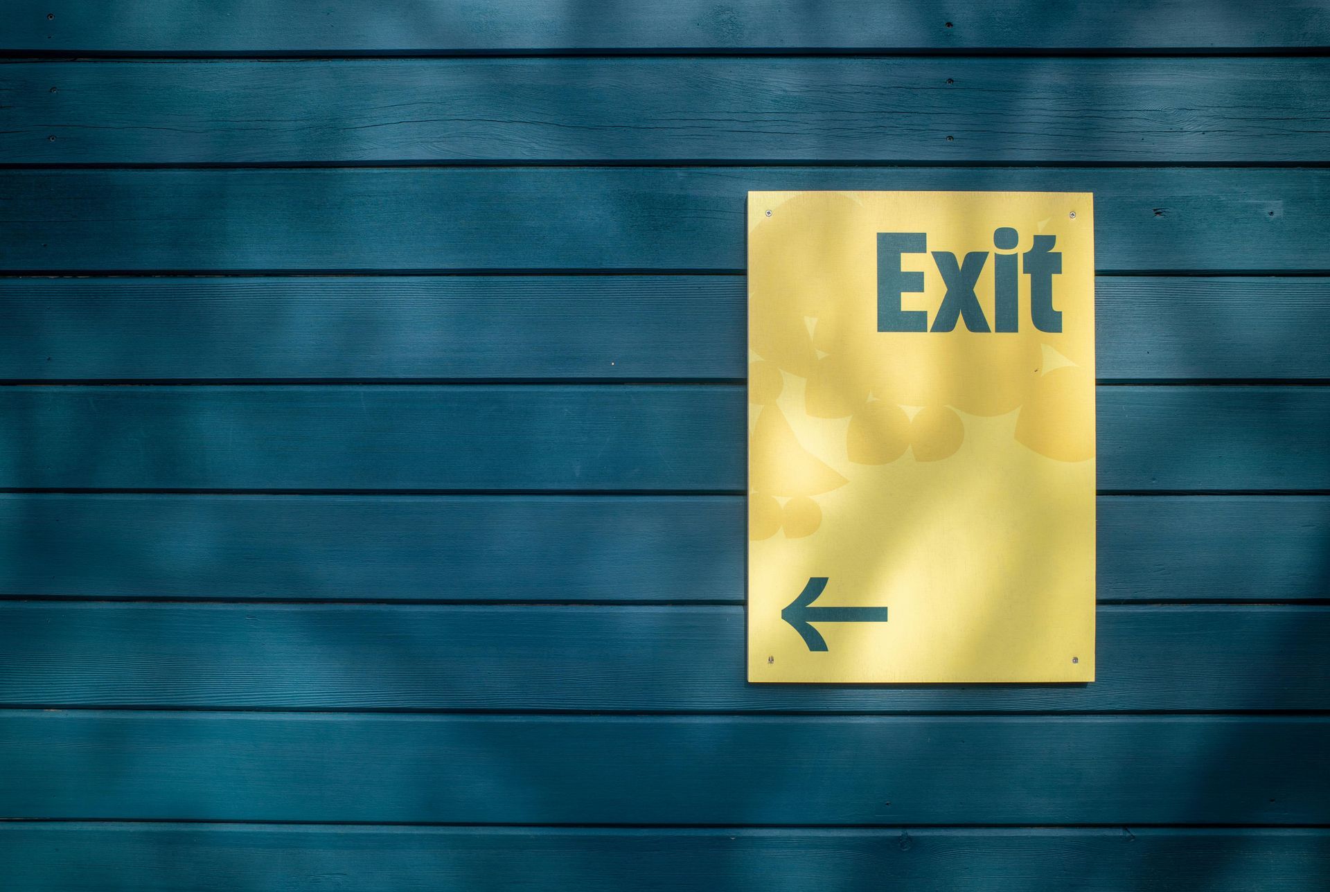 Emergency exit sign illustrating egress principles in access control