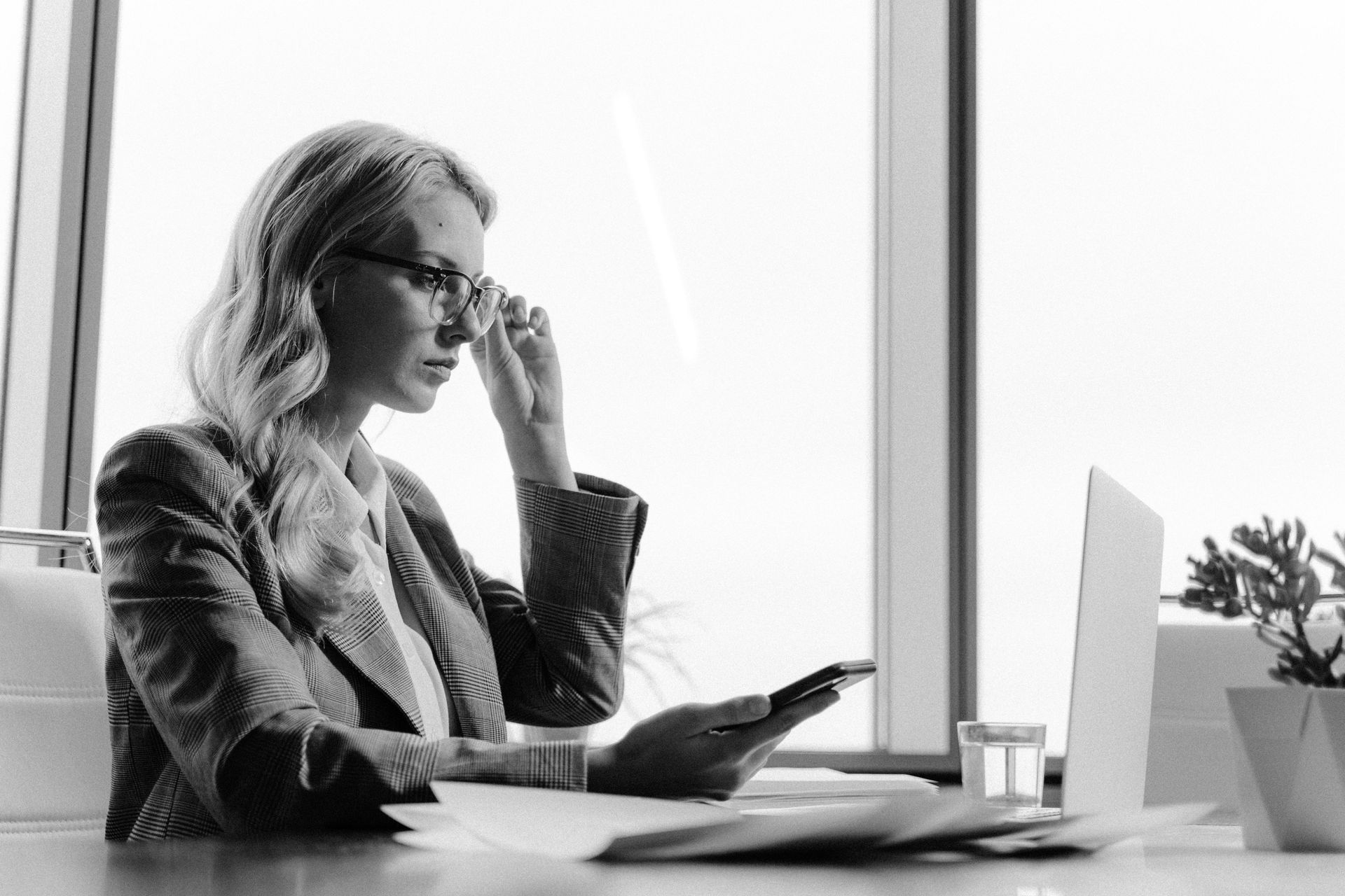 Female executive reviewing data centre security governance documents at a desk.