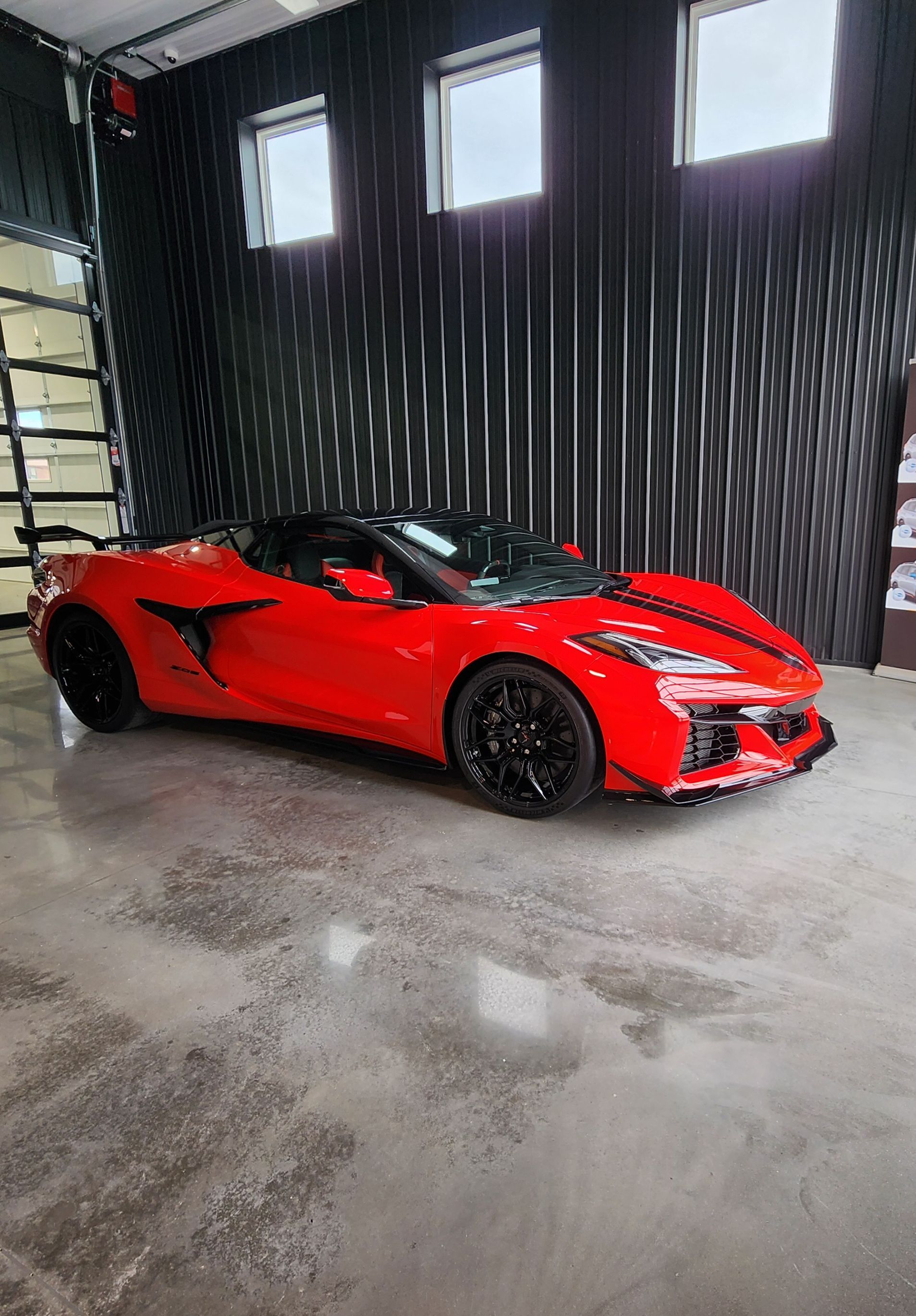 A person is washing a car wheel with foam