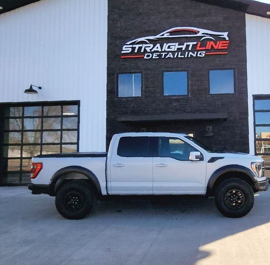 A man is holding a piece of glass with a picture of a cat on it