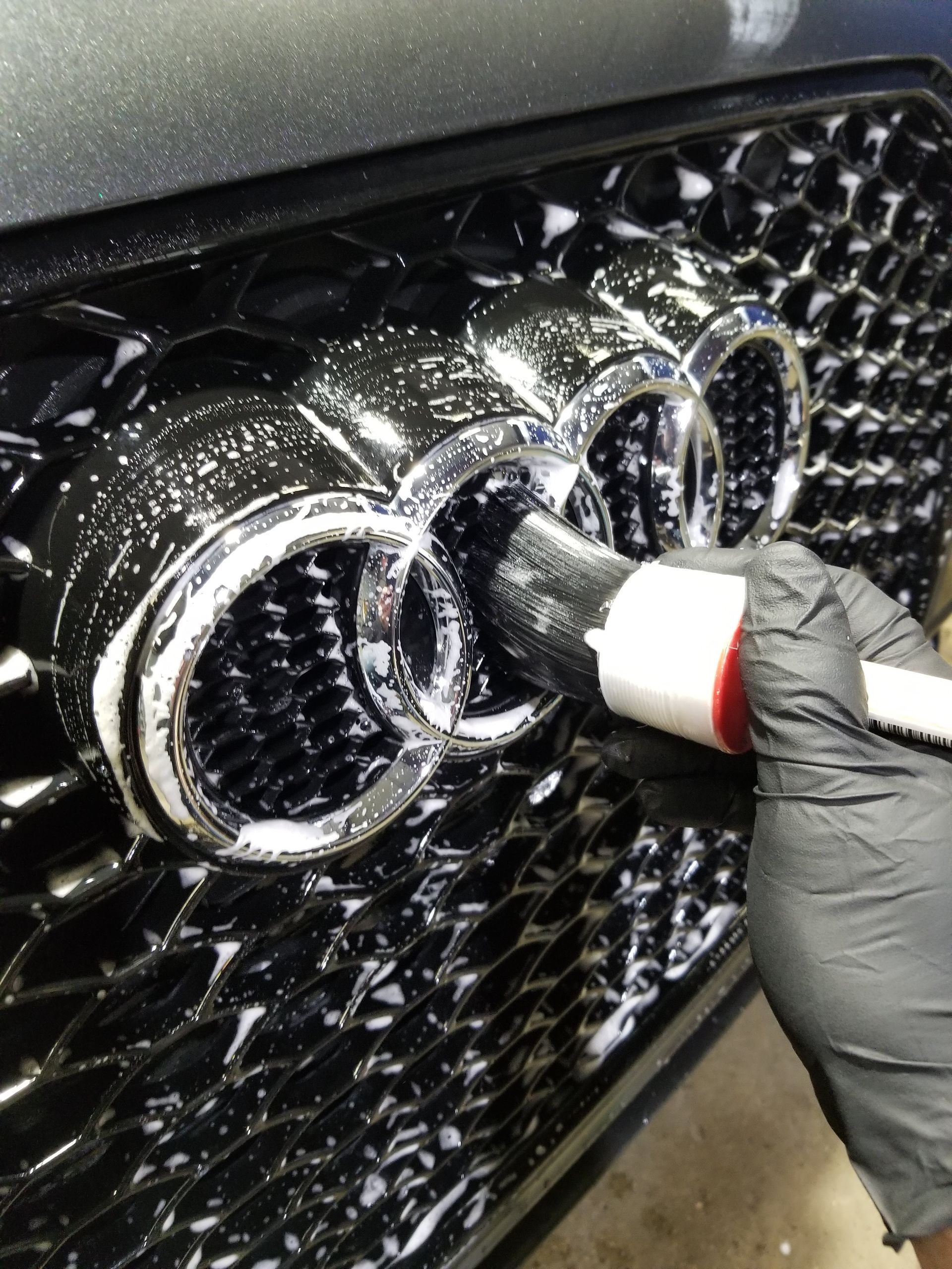 A close up of water drops on the hood of a car