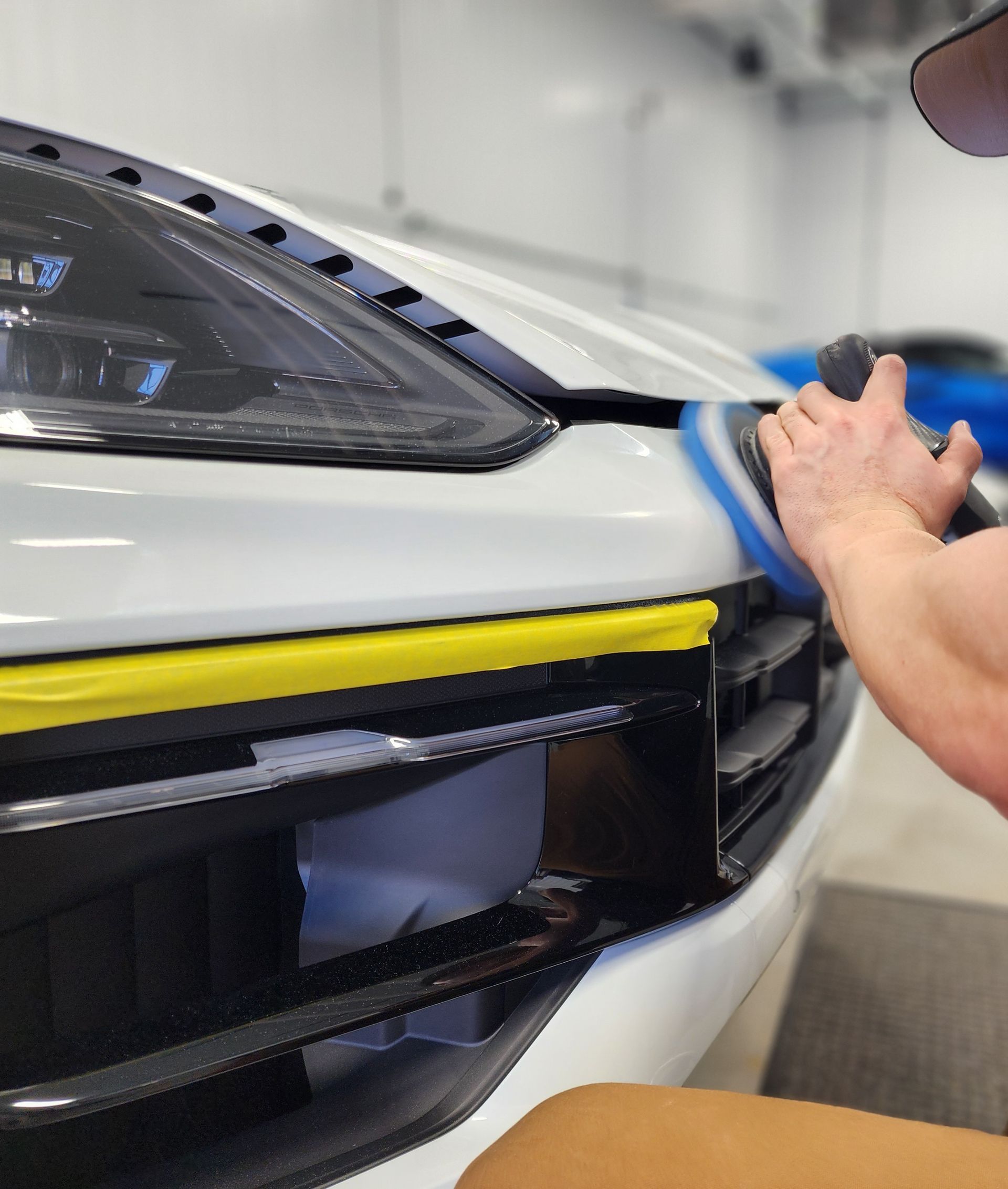 A person is applying tinted glass to a car window.