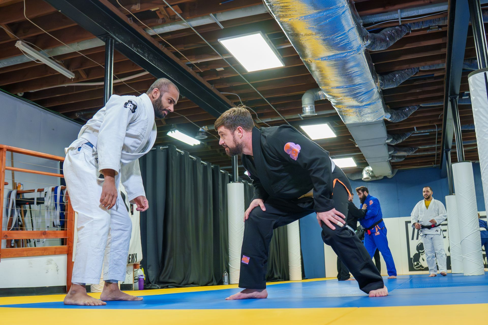 Adults drilling Jiu Jitsu techniques at Inverted Gear Academy in Bethlehem, PA to build strength.