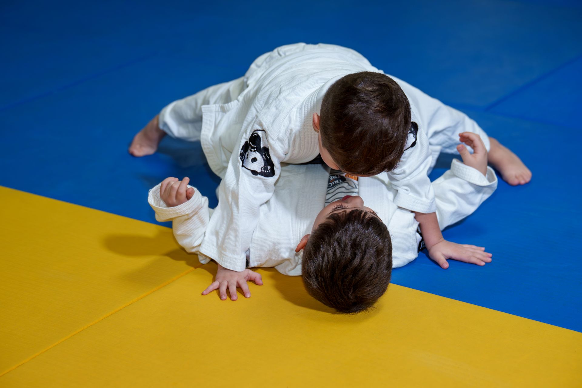 Kids and adults drilling Jiu Jitsu techniques at Inverted Gear Academy in Bethlehem, PA to build focus and strength.