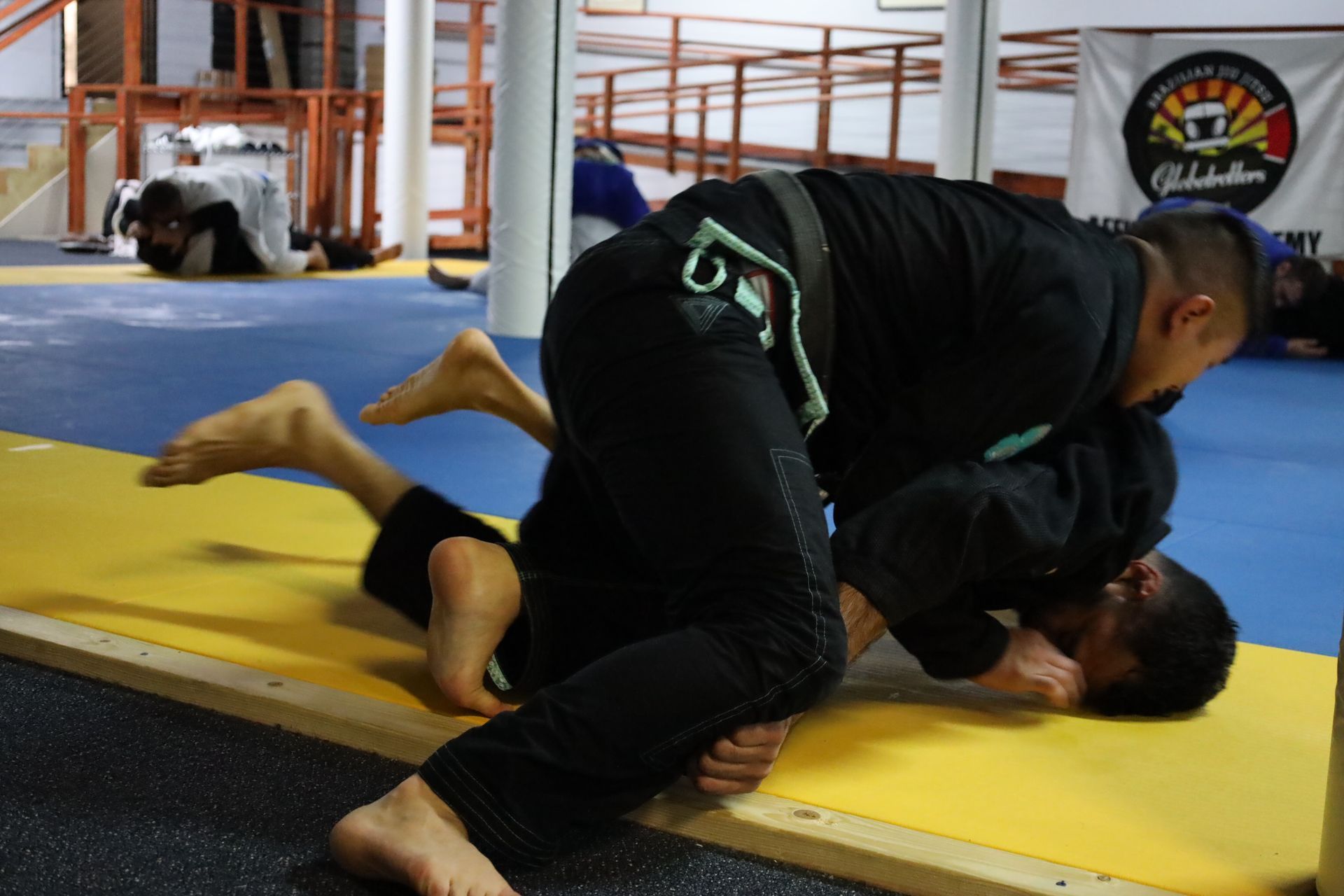 Adults practicing jiu-jitsu techniques at Inverted Gear Academy in Bethlehem PA building resilience through martial arts training