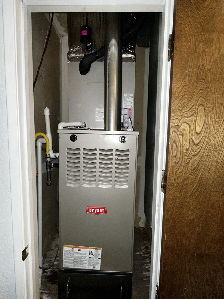 An air conditioner is sitting in a closet next to a door | Heating & Airflow