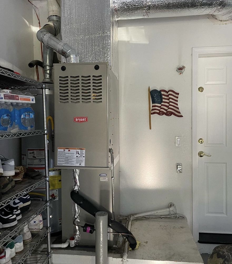 An american flag is hanging on a wall next to an air conditioner | Heating & Airflow
