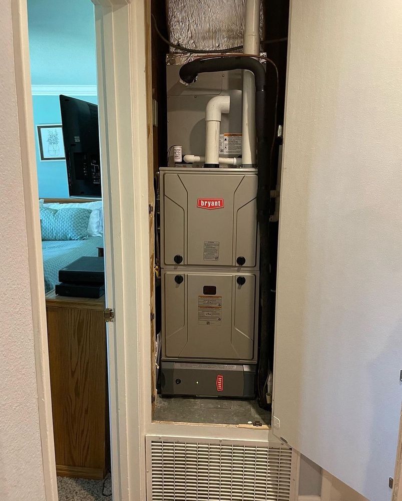 An air conditioner is sitting in a closet next to a door | Heating & Airflow