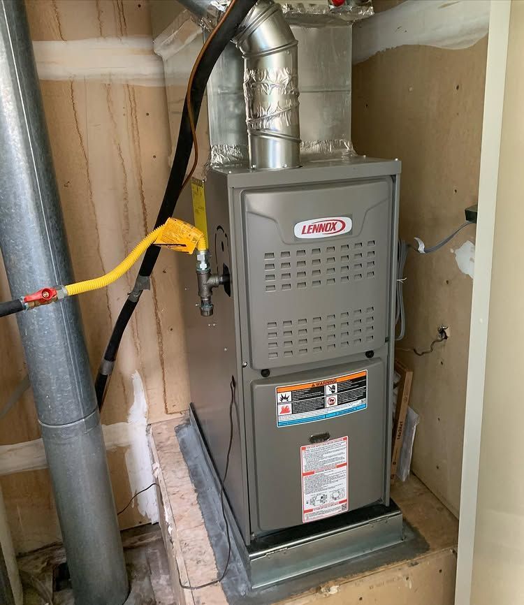 A furnace is sitting in a closet next to a pipe | Heating & Airflow