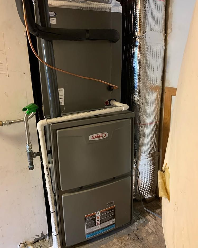 A furnace is sitting in a room next to a wall | Heating & Airflow