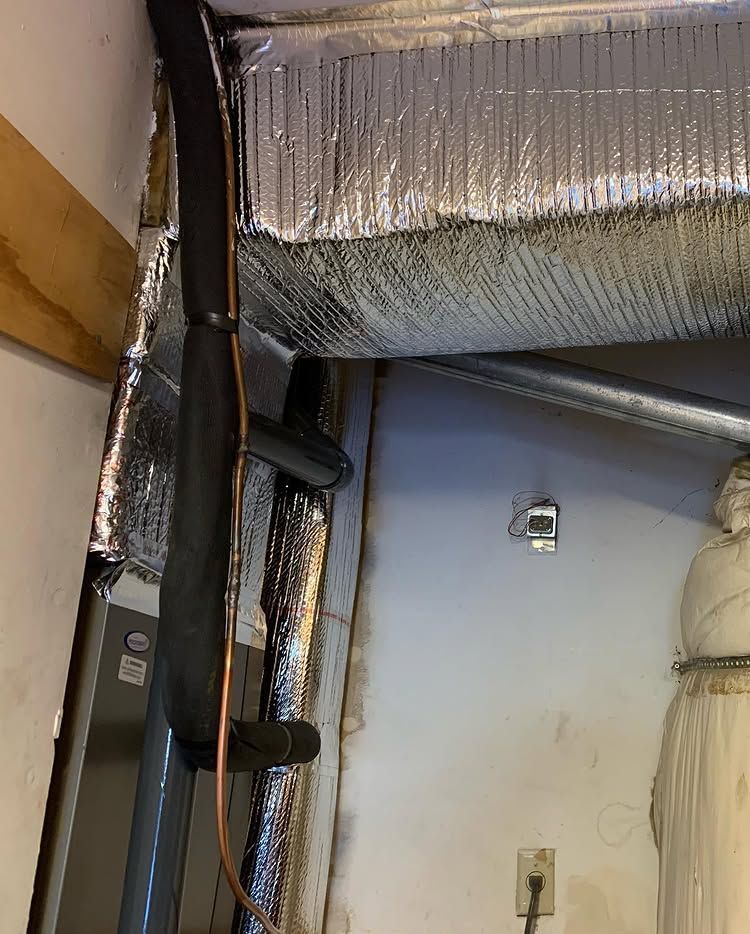 A pipe is hanging from the ceiling of a room | Heating & Airflow