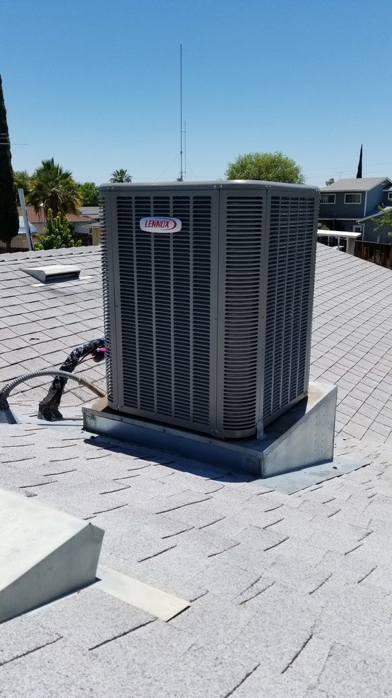 A large air conditioner is sitting on top of a roof | Heating & Airflow