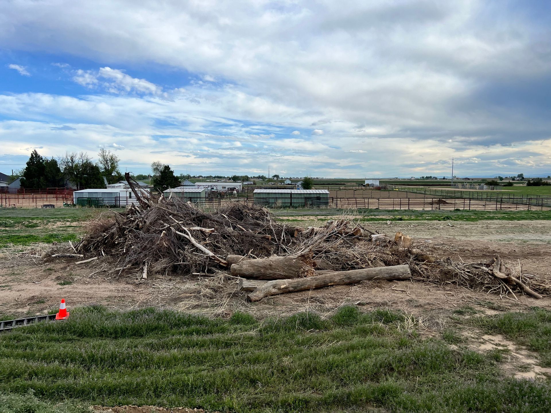 Two bulldozers are working on a dirt field.