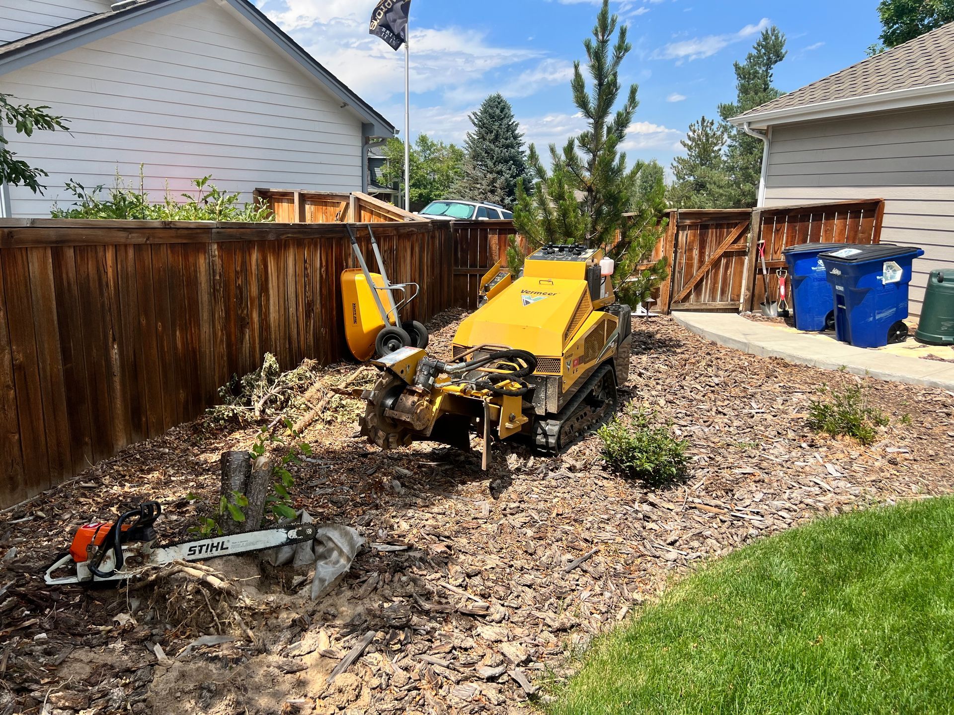 A person is cutting a tree trunk with a chainsaw.