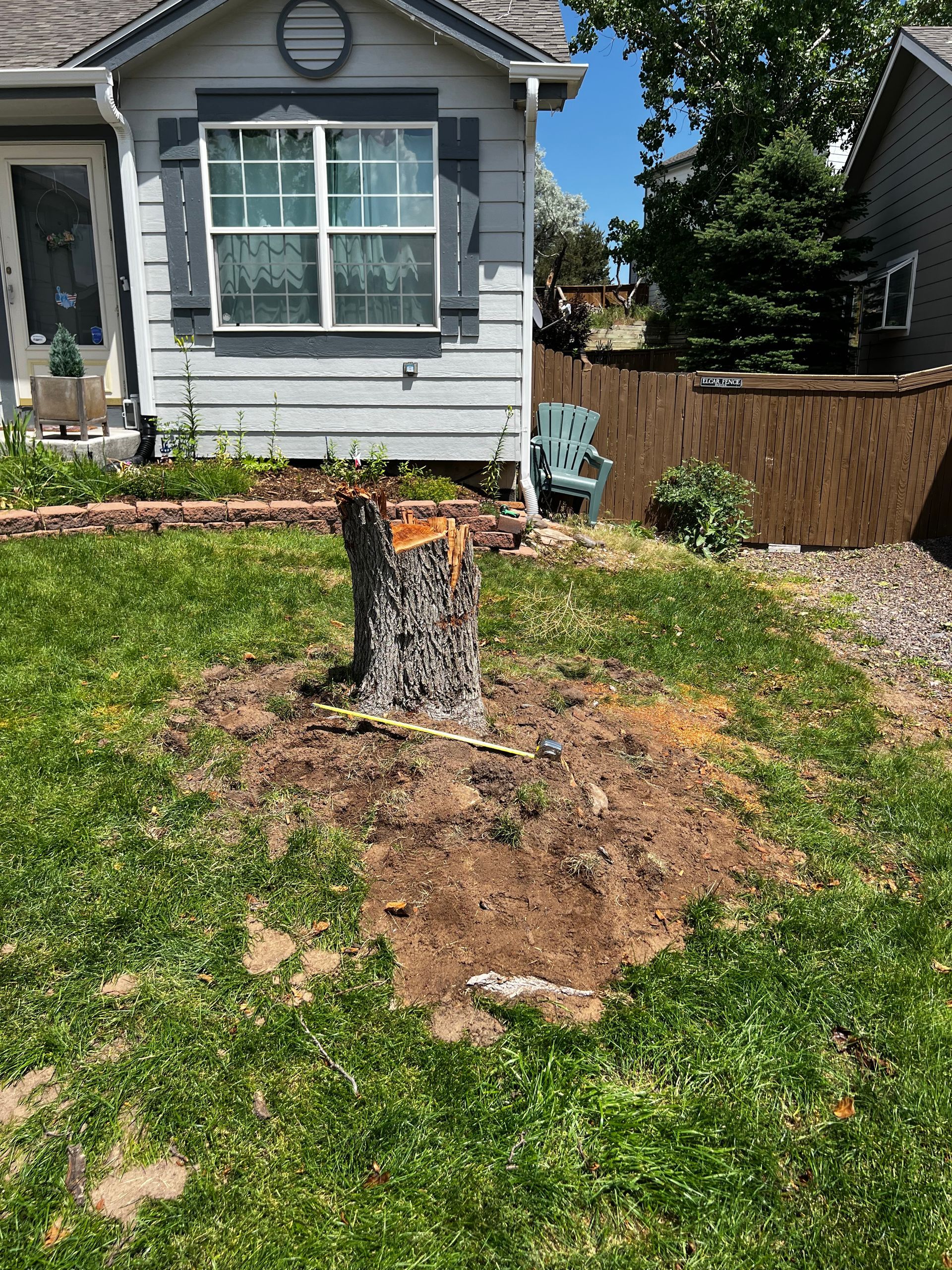 A large piece of wood is sitting on top of a pile of wood.