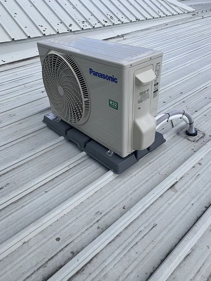 A Panasonic Air Conditioner is Sitting on Top of a Metal Roof — Northside Air Conditioning Services In Aspley, QLD