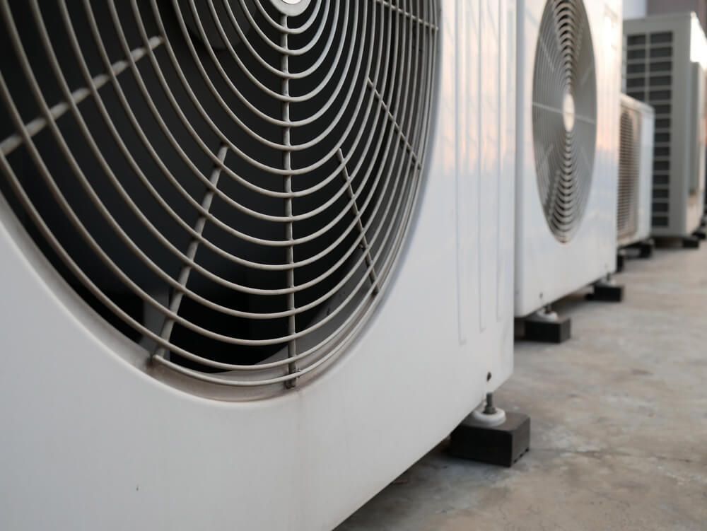 A Row of Air Conditioners Are Lined Up on the Ground — Northside Air Conditioning Services In Carseldine, QLD