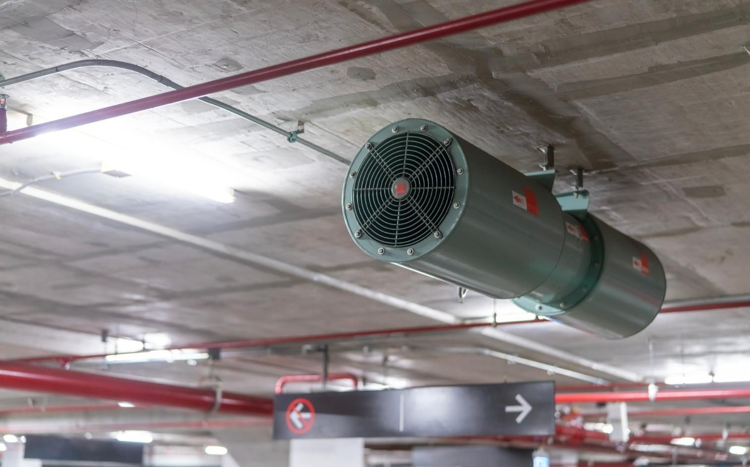 A Large Fan is Hanging From the Ceiling of a Parking Garage — Northside Air Conditioning Services In Gordon Park, QLD