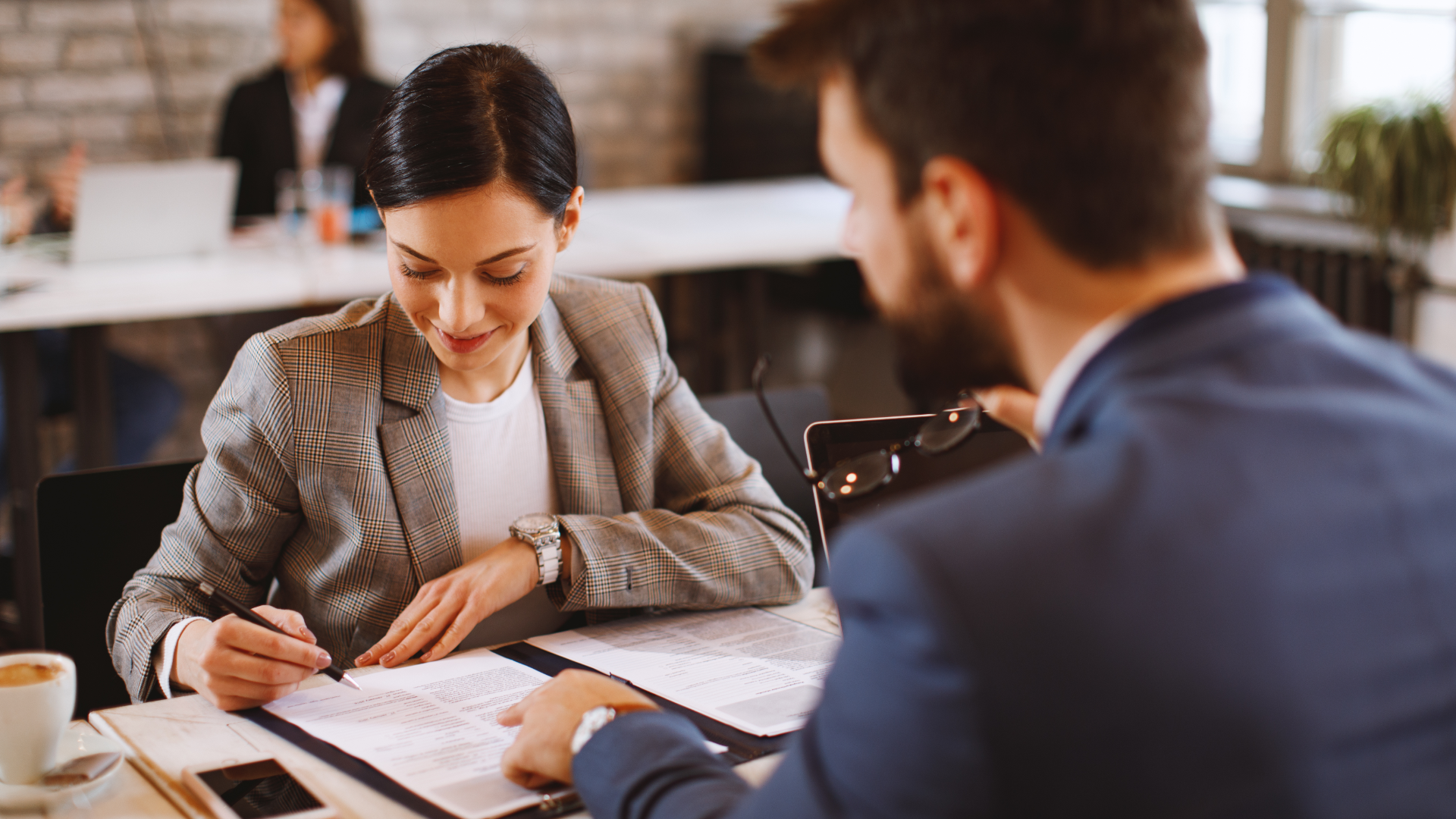A man and a woman are standing next to each other and smiling.