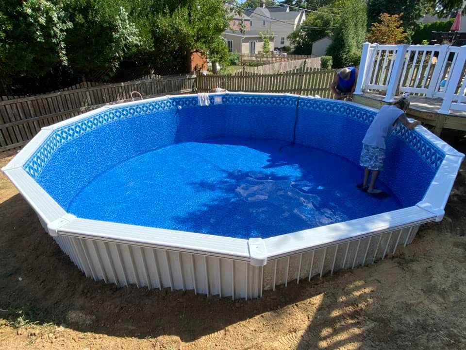 A man is standing in the middle of a swimming pool
