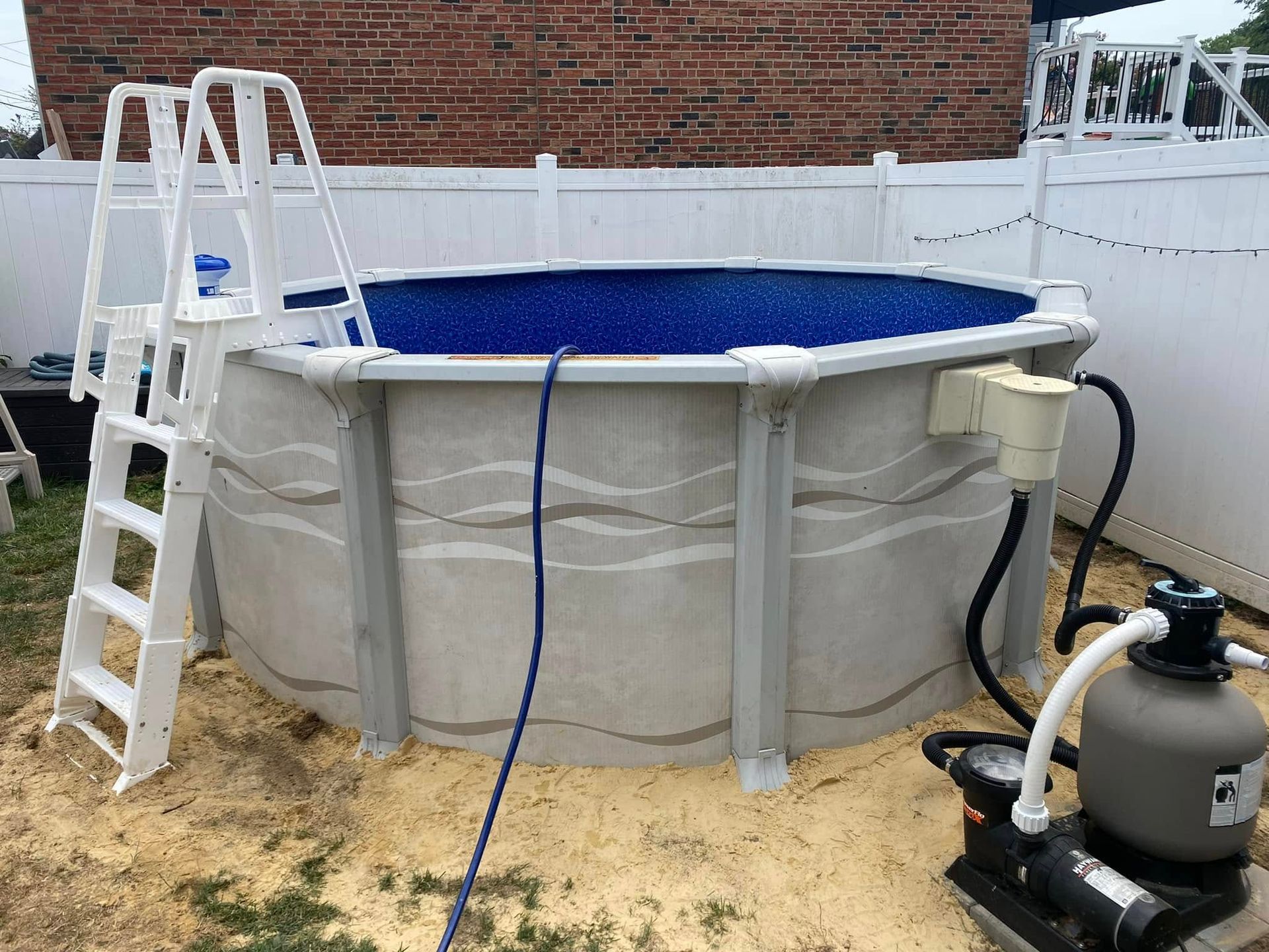 A swimming pool with a ladder and a filter attached to it.