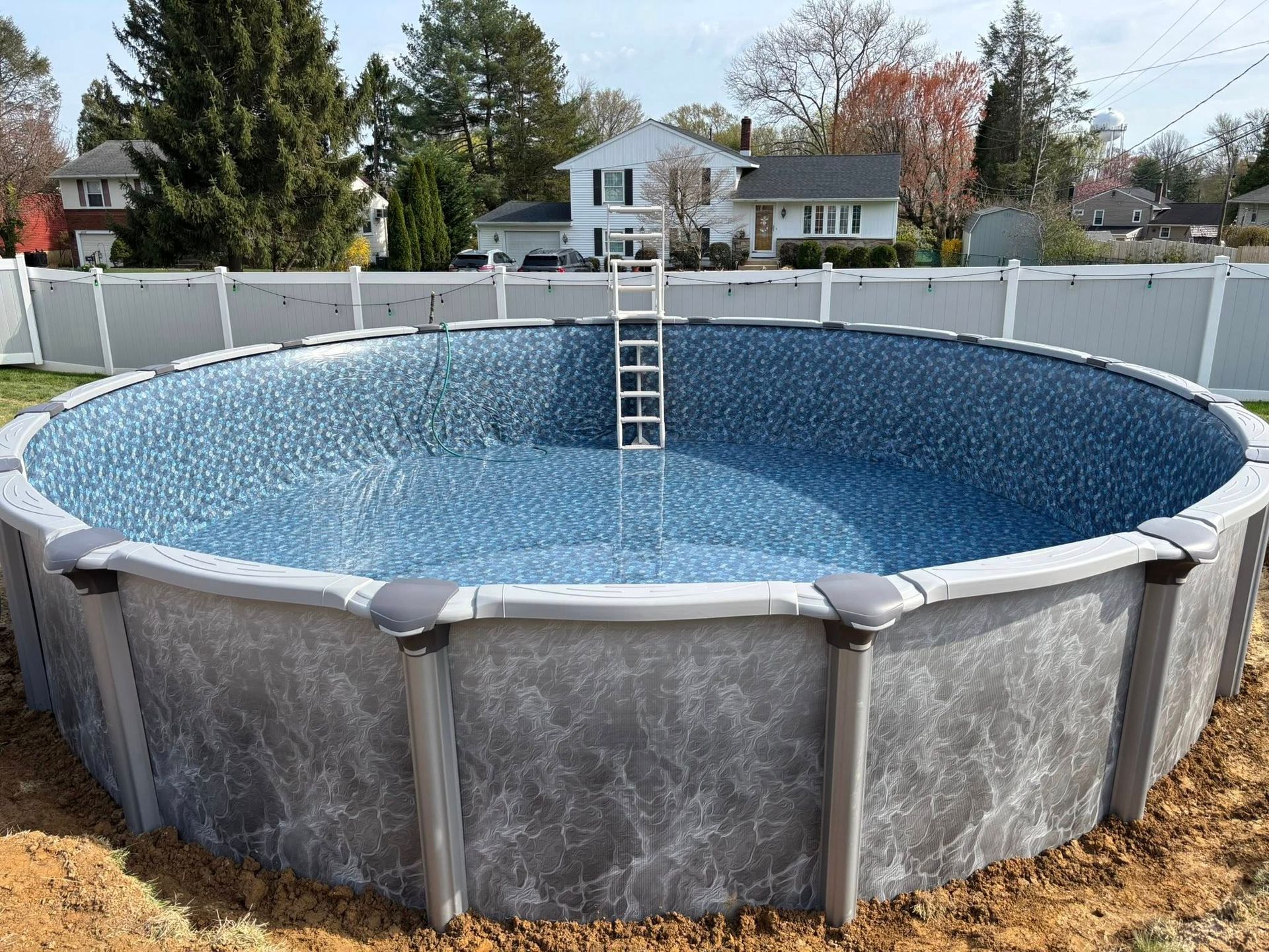 A large swimming pool with a ladder in the middle of it.