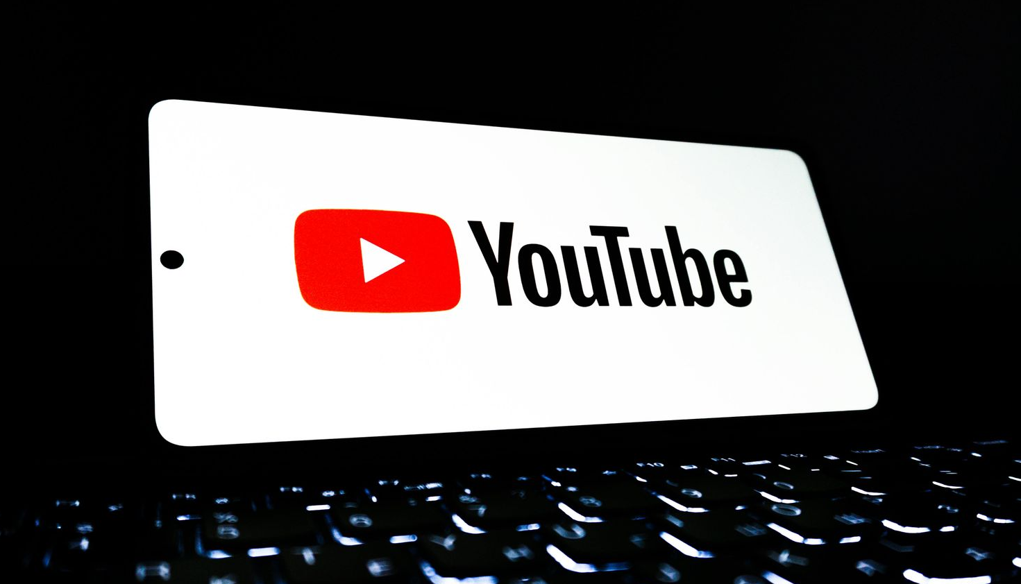 Close-up of laptop with YouTube logo on the screen