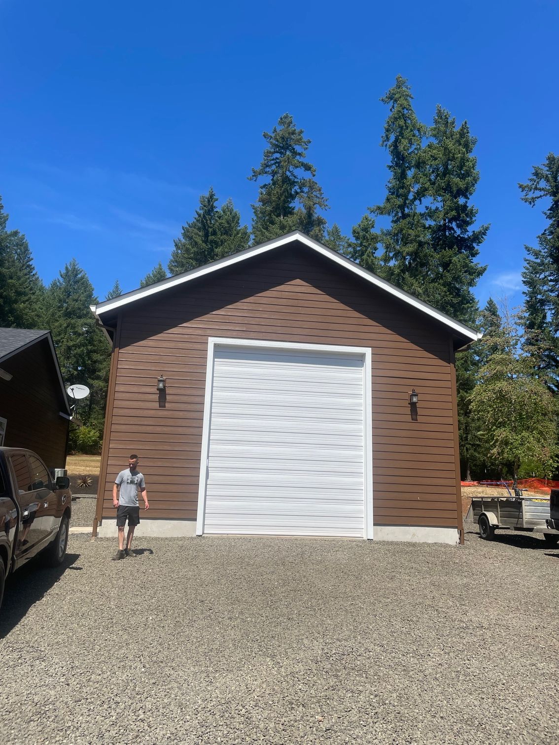 A large house with two garages and a driveway.