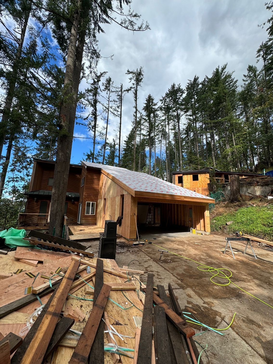 A white garage door is open in front of a house