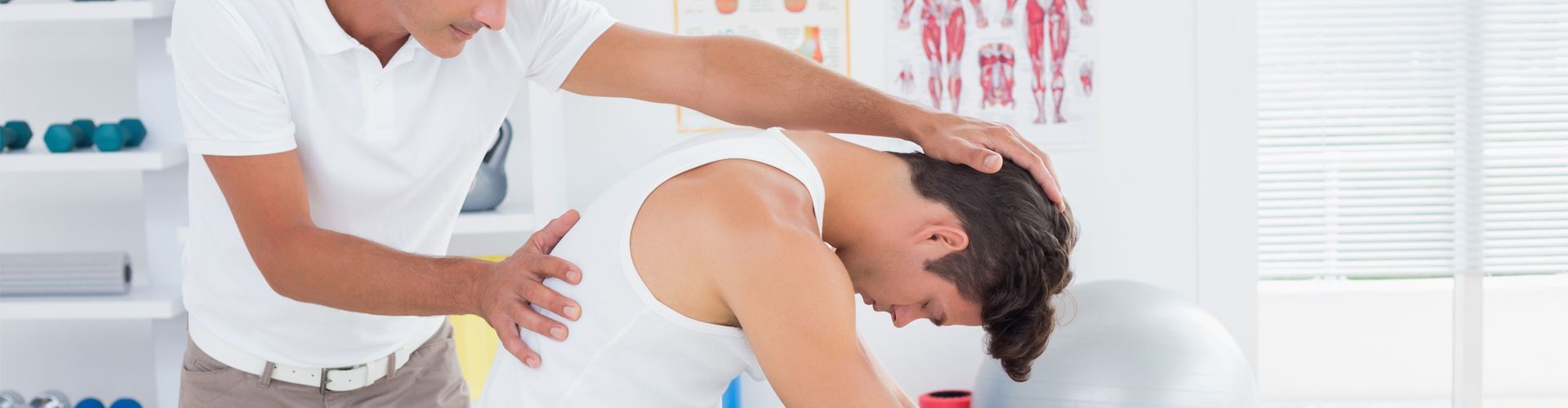 A man is getting his back examined by a doctor.