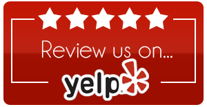 A red sign that says review us on yelp