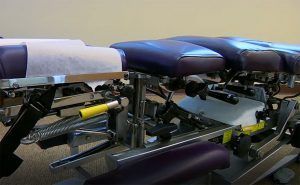 A close up of a massage table in a room.