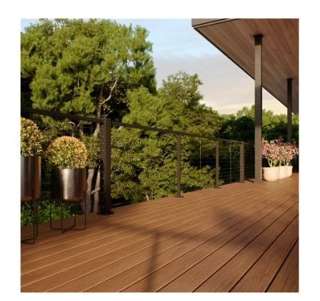 A wooden deck with planters and trees in the background