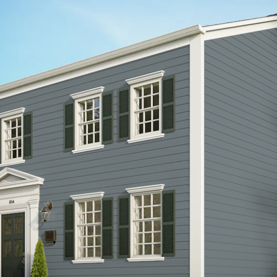 A gray house with white trim and green shutters