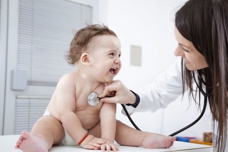 a baby is being examined by a doctor with a stethoscope .