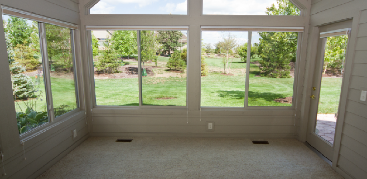 Modern vinyl windows overlooking a green Colorado lawn
